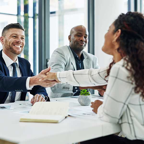 Shot of business people shaking hands in office