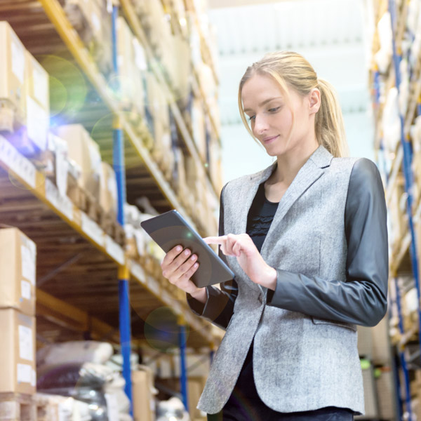 woman checking inventory in warehouse